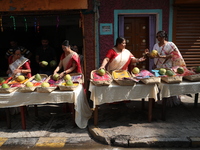 A woman arranges free religious materials to distribute to devotees who will perform prayers ahead of the Hindu religious festival of Chhat...