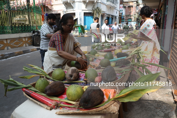 A woman arranges free religious materials to distribute to devotees who will perform prayers ahead of the Hindu religious festival of Chhat...