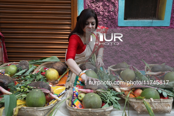 A woman arranges free religious materials to distribute to devotees who perform prayers ahead of the Hindu religious festival of Chhat Puja...