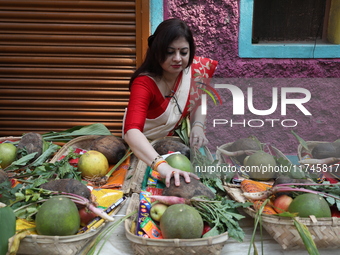 A woman arranges free religious materials to distribute to devotees who perform prayers ahead of the Hindu religious festival of Chhat Puja...