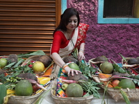 A woman arranges free religious materials to distribute to devotees who perform prayers ahead of the Hindu religious festival of Chhat Puja...