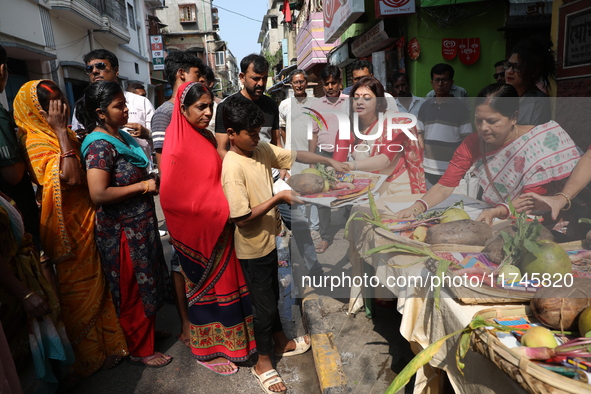 Devotees collect free religious material to perform prayers ahead of the Hindu religious festival of Chhat Puja in Kolkata, India, on Novemb...