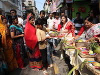 Devotees collect free religious material to perform prayers ahead of the Hindu religious festival of Chhat Puja in Kolkata, India, on Novemb...