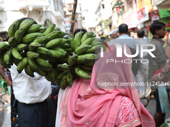 A devotee collects free religious material to perform prayers ahead of the Hindu religious festival of Chhat Puja in Kolkata, India, on Nove...