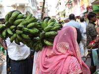 A devotee collects free religious material to perform prayers ahead of the Hindu religious festival of Chhat Puja in Kolkata, India, on Nove...