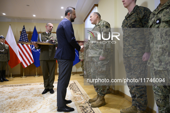 Poland's Deputy Prime Minister and Defence Minister, Wladyslaw Kosiniak-Kamysz, awards U.S. soldiers stationed in Poland for their service i...