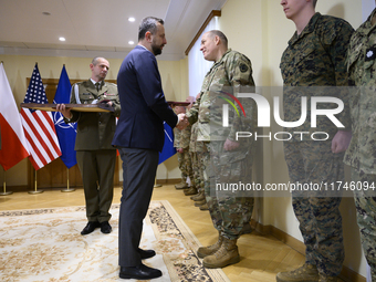 Poland's Deputy Prime Minister and Defence Minister, Wladyslaw Kosiniak-Kamysz, awards U.S. soldiers stationed in Poland for their service i...