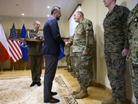 Poland's Deputy Prime Minister and Defence Minister, Wladyslaw Kosiniak-Kamysz, awards U.S. soldiers stationed in Poland for their service i...