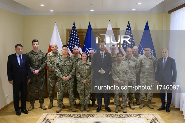 Poland's Deputy Prime Minister and Defence Minister, Wladyslaw Kosiniak-Kamysz, poses for a picture with U.S. soldiers after awarding them f...