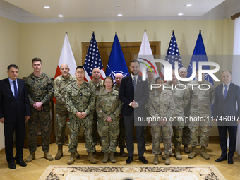 Poland's Deputy Prime Minister and Defence Minister, Wladyslaw Kosiniak-Kamysz, poses for a picture with U.S. soldiers after awarding them f...