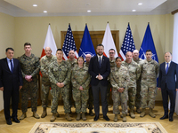 Poland's Deputy Prime Minister and Defence Minister, Wladyslaw Kosiniak-Kamysz, poses for a picture with U.S. soldiers after awarding them f...