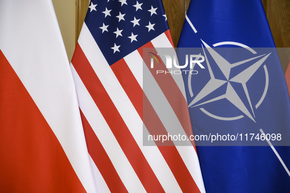 The flags of the USA, NATO, and Poland are pictured before the U.S. soldiers' medal award ceremony at the Ministry of Defence in Warsaw, Pol...