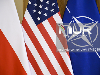 The flags of the USA, NATO, and Poland are pictured before the U.S. soldiers' medal award ceremony at the Ministry of Defence in Warsaw, Pol...