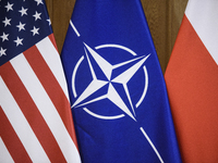 The flags of the USA, NATO, and Poland are pictured before the U.S. soldiers' medal award ceremony at the Ministry of Defence in Warsaw, Pol...