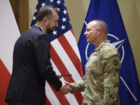 Poland's Deputy Prime Minister and Defence Minister, Wladyslaw Kosiniak-Kamysz, awards U.S. soldiers stationed in Poland for their service i...