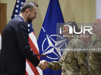 Poland's Deputy Prime Minister and Defence Minister, Wladyslaw Kosiniak-Kamysz, awards U.S. soldiers stationed in Poland for their service i...