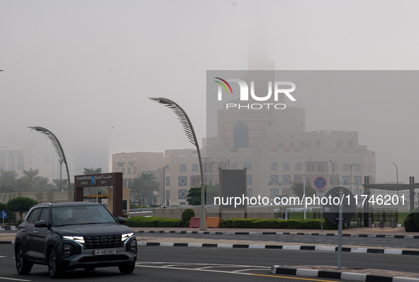 Vehicles drive on the street in heavy fog in Doha, Qatar, on November 6, 2024. 