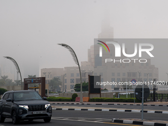 Vehicles drive on the street in heavy fog in Doha, Qatar, on November 6, 2024. (