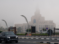 Vehicles drive on the street in heavy fog in Doha, Qatar, on November 6, 2024. (