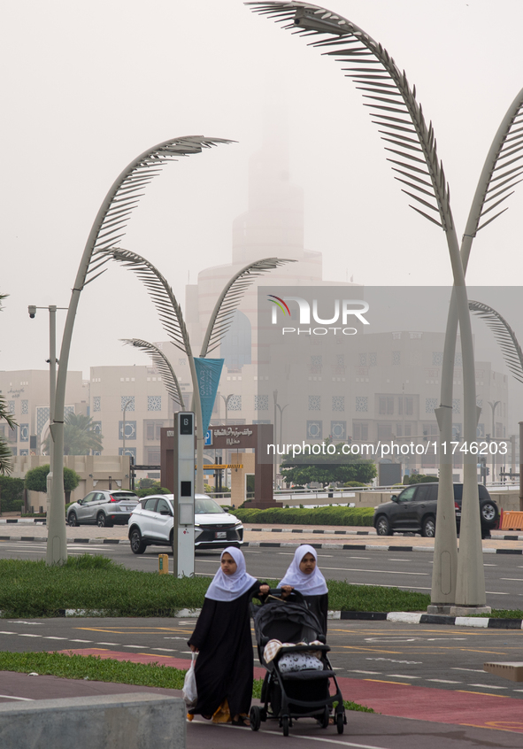 Vehicles drive on the street in heavy fog in Doha, Qatar, on November 6, 2024. 