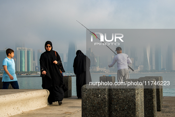 People fish at the Doha Corniche in heavy fog in Doha, Qatar, on November 6, 2024. 