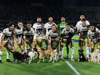 Players of the Pumas de la UNAM pose with dogs for adoption prior to the match corresponding to matchday 16 of the Apertura 2024 tournament...