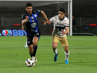 Rodrigo Lopez #7 of Pumas de la UNAM and Alan Medina #11 of Queretaro fight for the ball during the match corresponding to round 16 of the A...