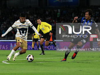 Piero Quispe #27 of Pumas de la UNAM and Jose Canale #6 of Queretaro fight for the ball during the match corresponding to round 16 of the Ap...