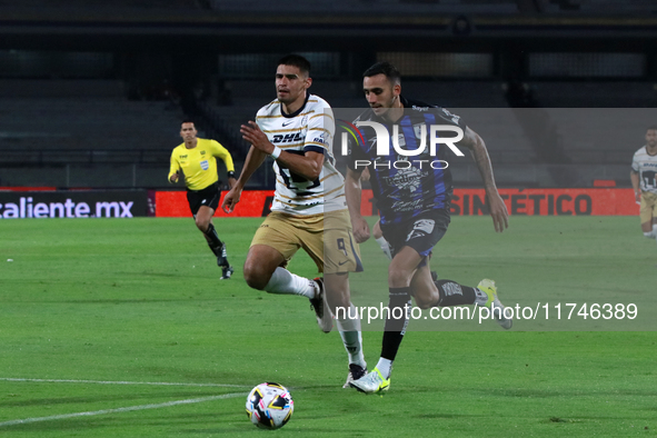 Guillermo Martinez #9 of Pumas de la UNAM and Franco Russo #4 of Queretaro fight for the ball during the match corresponding to round 16 of...