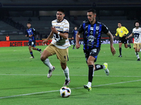 Guillermo Martinez #9 of Pumas de la UNAM and Franco Russo #4 of Queretaro fight for the ball during the match corresponding to round 16 of...