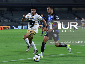 Guillermo Martinez #9 of Pumas de la UNAM and Franco Russo #4 of Queretaro fight for the ball during the match corresponding to round 16 of...