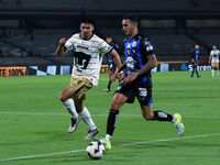 Guillermo Martinez #9 of Pumas de la UNAM and Franco Russo #4 of Queretaro fight for the ball during the match corresponding to round 16 of...