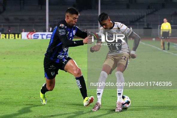 Robert Ergas #22 of Pumas de la UNAM and Federico Lertora #14 of Queretaro fight for the ball during the match corresponding to round 16 of...