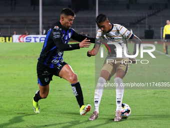 Robert Ergas #22 of Pumas de la UNAM and Federico Lertora #14 of Queretaro fight for the ball during the match corresponding to round 16 of...