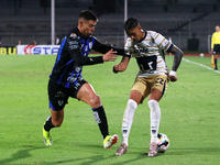 Robert Ergas #22 of Pumas de la UNAM and Federico Lertora #14 of Queretaro fight for the ball during the match corresponding to round 16 of...