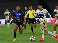 Ignacio Pussetto #23 of Pumas de la UNAM and Omar Mendoza #2 of Queretaro fight for the ball during the match corresponding to round 16 of t...