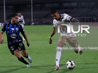 Robert Ergas #22 of Pumas de la UNAM and Juan Robles #187 of Queretaro fight for the ball during the match corresponding to round 16 of the...