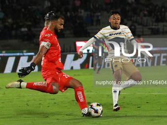 Goalkeeper Guillermo Allison #25 of Queretaro and Angel Rico #189 of Pumas de la UNAM fight for the ball during the match corresponding to r...