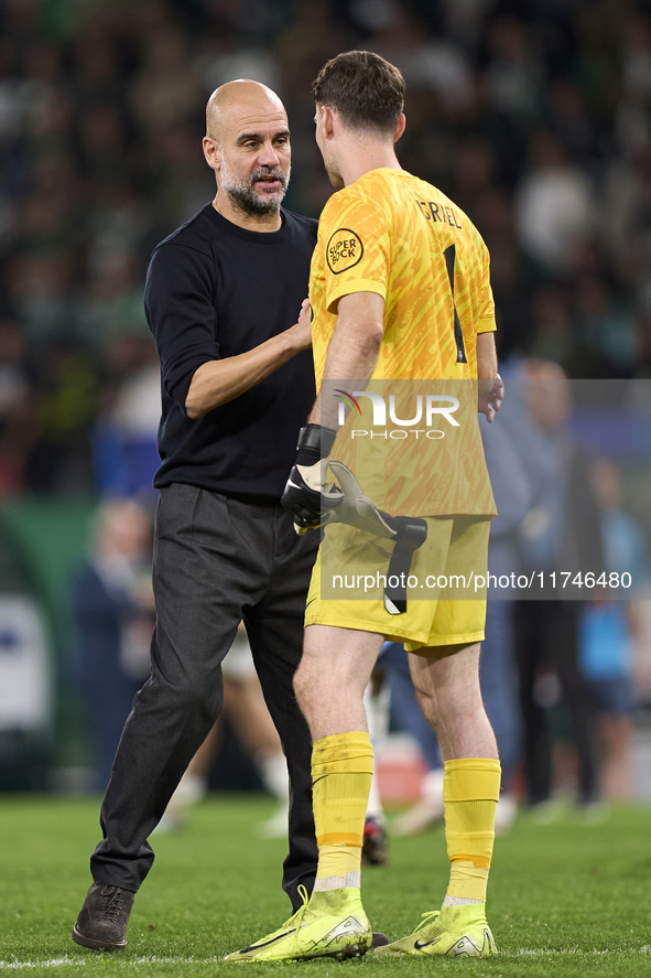 Pep Guardiola, Head Coach of Manchester City, greets Franco Israel of Sporting CP after the UEFA Champions League match between Sporting CP...