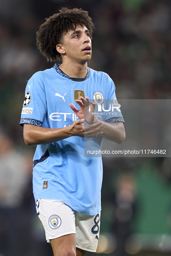 Rico Lewis of Manchester City shows appreciation to the fans after the UEFA Champions League match between Sporting CP and Manchester City a...