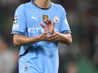 Rico Lewis of Manchester City shows appreciation to the fans after the UEFA Champions League match between Sporting CP and Manchester City a...