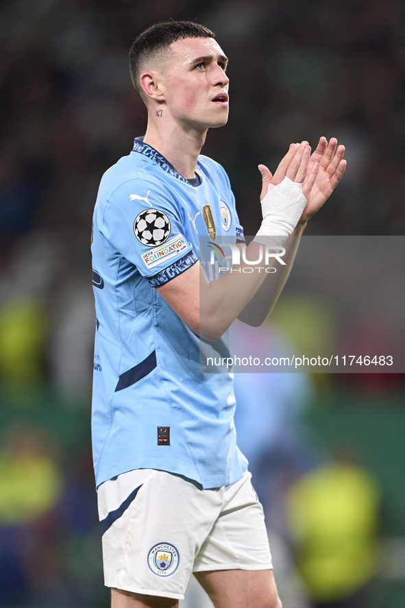 Phil Foden of Manchester City shows appreciation to the fans after the UEFA Champions League match between Sporting CP and Manchester City a...