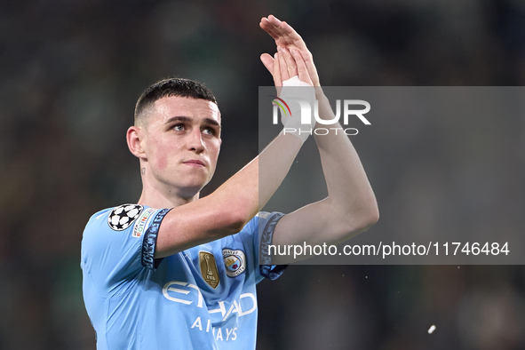 Phil Foden of Manchester City shows appreciation to the fans after the UEFA Champions League match between Sporting CP and Manchester City a...