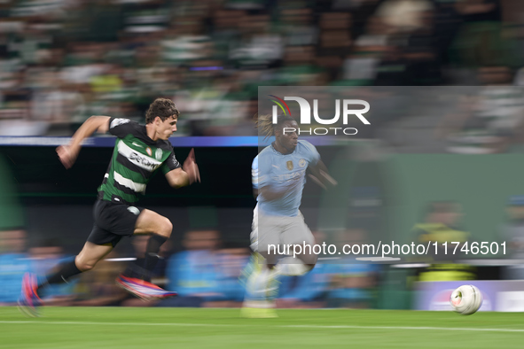 Jeremy Doku of Manchester City is challenged by Eduardo Quaresma of Sporting CP during the UEFA Champions League match between Sporting CP a...