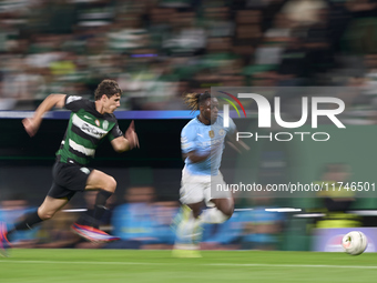 Jeremy Doku of Manchester City is challenged by Eduardo Quaresma of Sporting CP during the UEFA Champions League match between Sporting CP a...