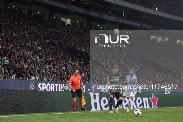 Savinho of Manchester City competes for the ball with Maxi Araujo of Sporting CP during the UEFA Champions League match between Sporting CP...