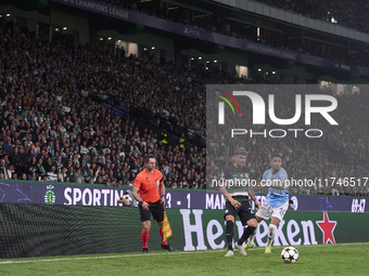 Savinho of Manchester City competes for the ball with Maxi Araujo of Sporting CP during the UEFA Champions League match between Sporting CP...