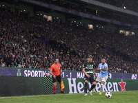 Savinho of Manchester City competes for the ball with Maxi Araujo of Sporting CP during the UEFA Champions League match between Sporting CP...