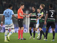 Referee Daniel Siebert and players of Sporting CP discuss during the UEFA Champions League match between Sporting CP and Manchester City at...