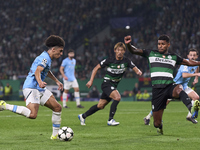 Rico Lewis of Manchester City is challenged by Matheus Reis of Sporting CP during the UEFA Champions League match between Sporting CP and Ma...